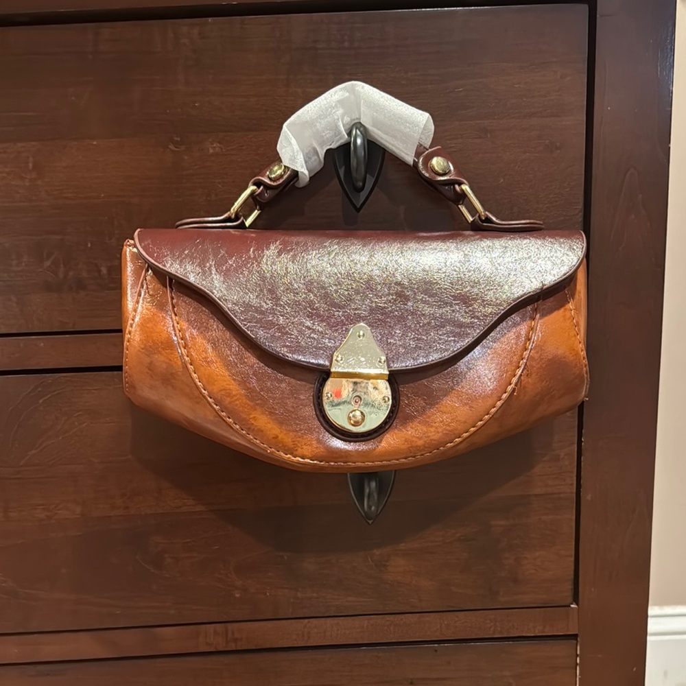 Brown Vegan Leather Clutch with Decorative Clasp and Structured Design